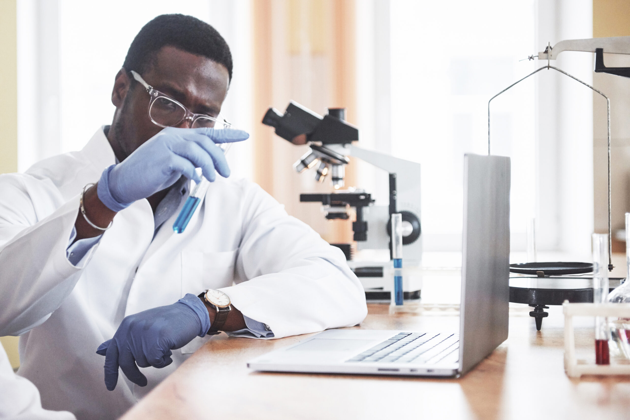 An African American worker works in a laboratory conducting experiments